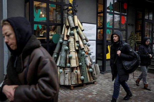 People pass by a symbolic Christmas tree made from used artillery shells and parts of rockets who were transported to the Ukrainian capital from the front line, amid Russia's attack on Ukraine, in central Kyiv, Ukraine on December 19. (Reuters)