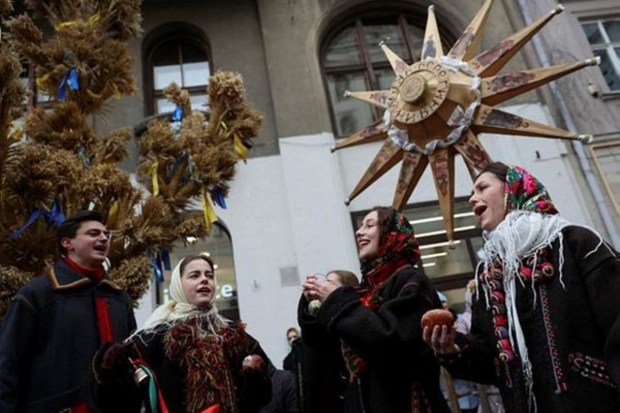 Locals dressed in Ukrainian traditional costumes attend a Christmas celebration in Lviv, Ukraine, on December 24. (Reuters)