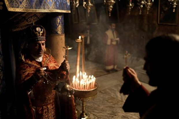 Christian Armenian priests pray in the Grotto, under the Church of the Nativity, traditionally believed to be the birthplace of Jesus, in the West Bank city of Bethlehem. (AP)