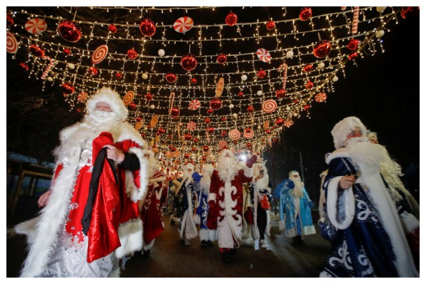 Dressed as Ayaz Ata (Father Frost), participants bring merriment to the streets during a procession in Almaty, Kazakhstan, commemorating the New Year and Christmas season. (Image: Reuters)
