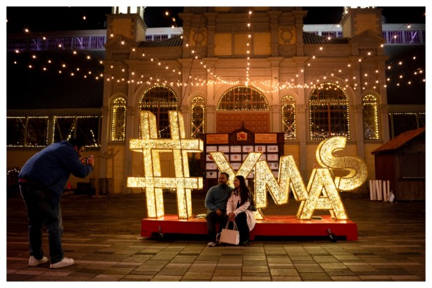 Smiles and poses fill the scene as people capture moments at a Christmas-themed attraction in Lansdowne Park, Ottawa, Ontario, on December 25, 2023. (Image: AP/PTI)