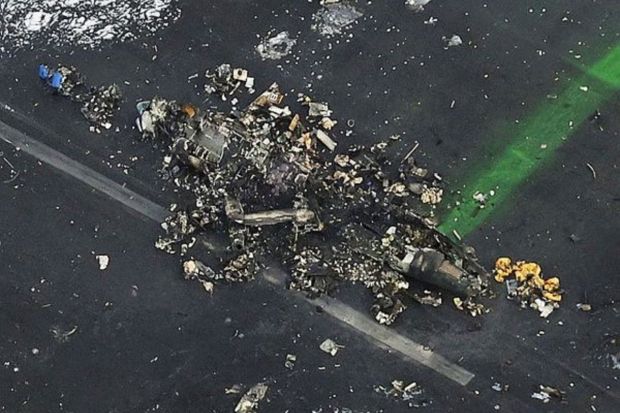 This aerial photo shows the burn-out Japanese coast guard aircraft at Haneda airport on Wednesday, Jan. 3, 2024, in Tokyo, Japan. A large passenger plane and the Japanese coast guard aircraft collided on the runway at Tokyo's Haneda Airport on Tuesday and burst into flames, killing several people aboard the coast guard plane, officials said. (Photo: AP)