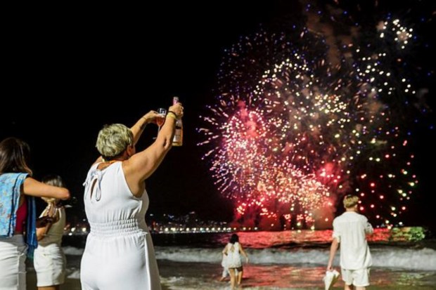 People celebrate the New Year as fireworks explode in the sky over the Copacabana beach in Rio de Janeiro, Brazil, On January 1. (Reuters)