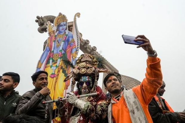 A man takes selfie with an artist at the Lata Mangeshkar Chowk ahead of the consecration ceremony of the Ram Mandir in Ayodhya. (PTI Photo/Kamal Kishore)