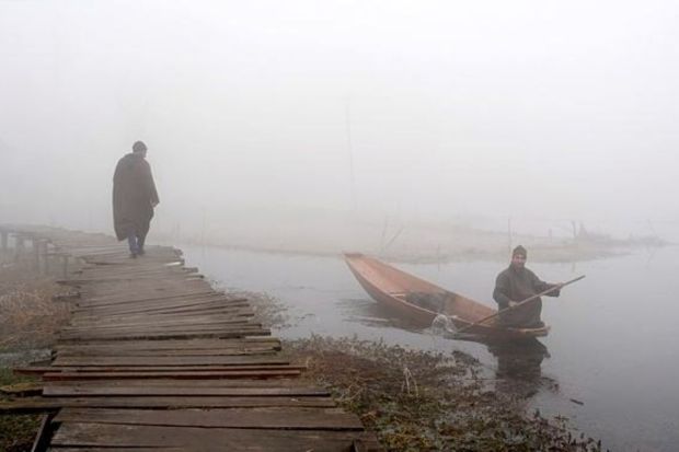 A thin layer of ice formed on the surface of the Dal Lake here on Monday and other water bodies in Kashmir due to the intense cold wave that is gripping the region. (PTI Photo)