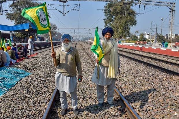 Bharatiya Kisan Union members block railway tracks at Rajpura as they stage 'rail roko' protest in support of farmers agitating at Punjab-Haryana Shambhu border, in Patiala. (PTI Photo)