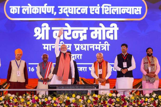 Prime Minister Narendra Modi with Haryana Governor Bandaru Dattatreya, the Chief Minister Manohar Lal and others in Rewari district. (PTI Photo)