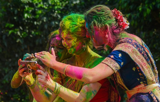Foreign nationals play Holi during 'Dol Yatra' festival celebrations, in Howrah (PTI)