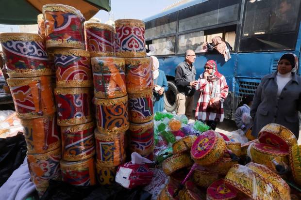 An Egyptian woman looks at prices of traditional decorative Ramadan lanterns called 