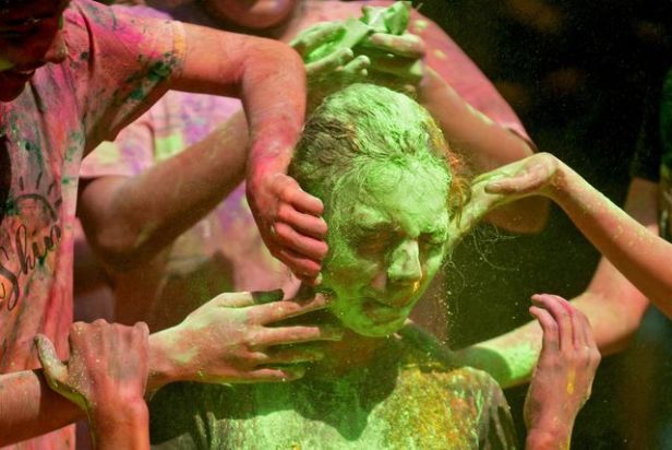 A girl reacts as coloured powder is applied to her face during Holi celebrations in Mumbai (PTI)