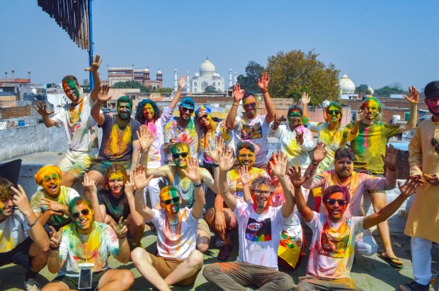 Foreign nationals during Holi celebrations in the backdrop of the Taj Mahal, in Agra (PTI)