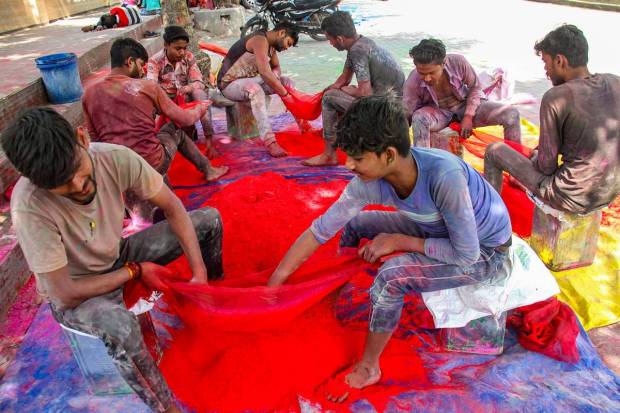 Workers dry coloured powder 'Gulal' ahead of the Holi festival, in Gurugram. (PTI Photo)