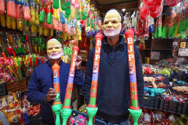 Vendors arrange water guns printed with Prime Minister Narendra Modi's pictures and BJP symbol at a shop, ahead of the festival of 'Holi', in Jammu. (PTI Photo)