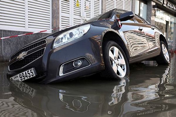 A car is stranded in flood water caused by heavy rains