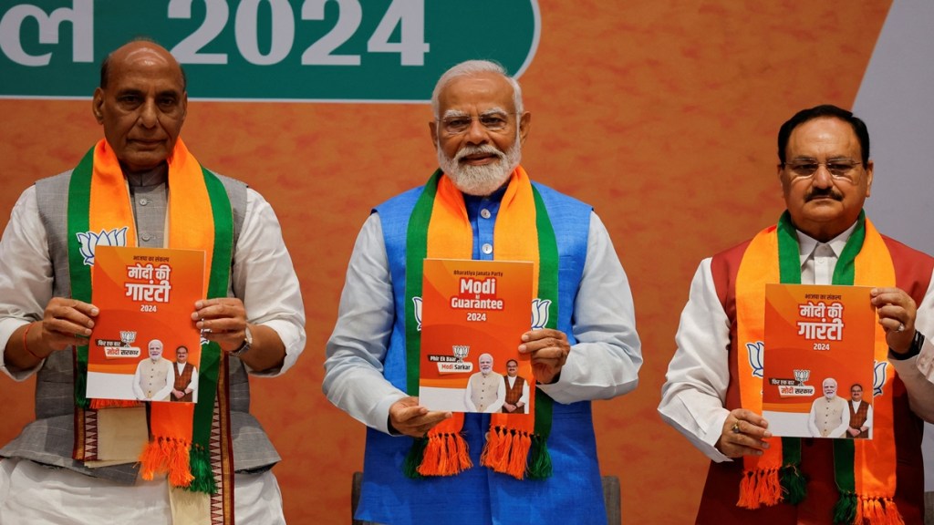 Indian Defence Minister Rajnath Singh, Prime Minister Narendra Modi and President of the Bharatiya Janata Party J. P. Nadda display copies of the ruling Bharatiya Janata Party's (BJP) election manifesto for the general election, in New Delhi, India, April 14, 2024. REUTERS/Adnan Abidi
