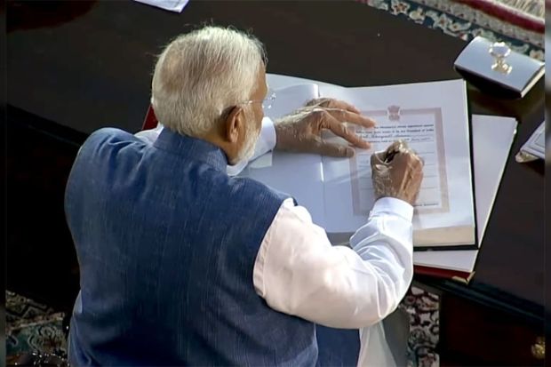 PM-designate Narendra Modi signed the copy after taking oath as Prime Minister for the third consecutive term at Rashtrapati Bhavan in New Delhi on Sunday, June 9, 2024.(Photo: PTI)