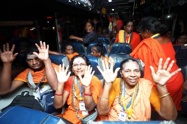 Pilgrims chant religious slogans after boarding a bus as they leave for the annual Amarnath Yatra, in Jammu on Saturday. (PTI Photo)