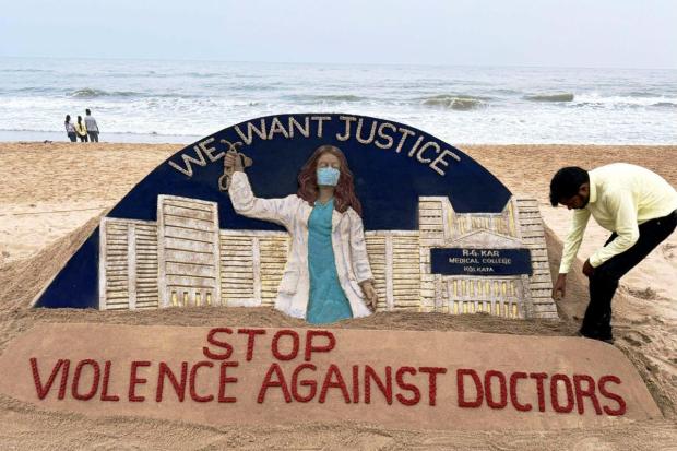 Puri: Sand artist Sudarsan Pattnaik creates a sculpture on the recent alleged rape and murder of a trainee doctor at Kolkata's RG Kar Medical College and Hospital, at the beach in Puri. (PTI)