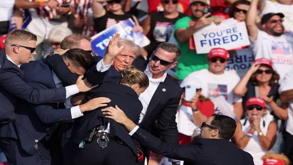 Republican presidential candidate and former US President Donald Trump seen in this image with a bloodied face while he is shielded by Secret Service personnel. (Photo source: Reuters) 