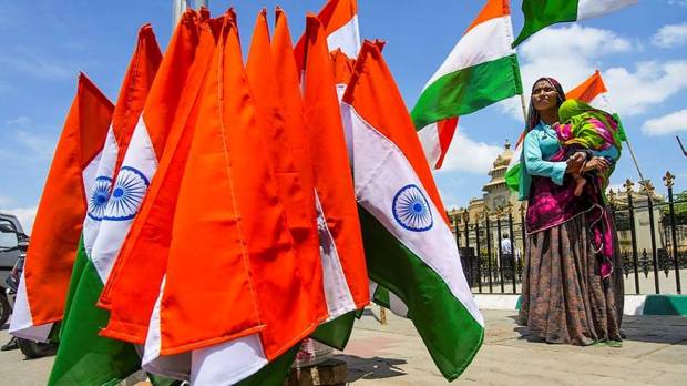 A vendor sells national flags near the Vidhana Soudha ahead of the 78th Independence Day celebration, in Bengaluru. (Photo source: PTI)