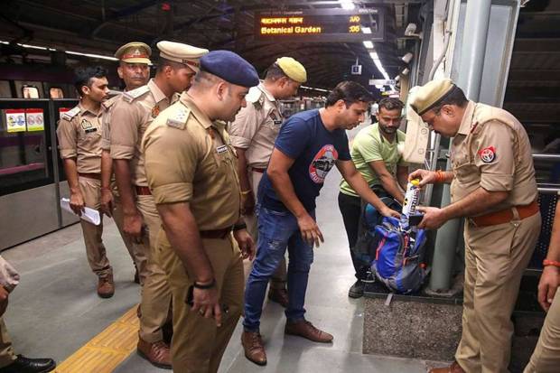 Police personnel while checking a commuter's bag as security has been tightened ahead of Independence Day, at a metro station in Noida. (Photo source: PTI)