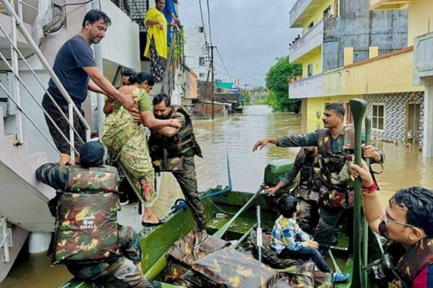Personnel from the Indian Army recover stranded people from the flooded Sama neighbourhood in Vadodara. (PTI Photo)