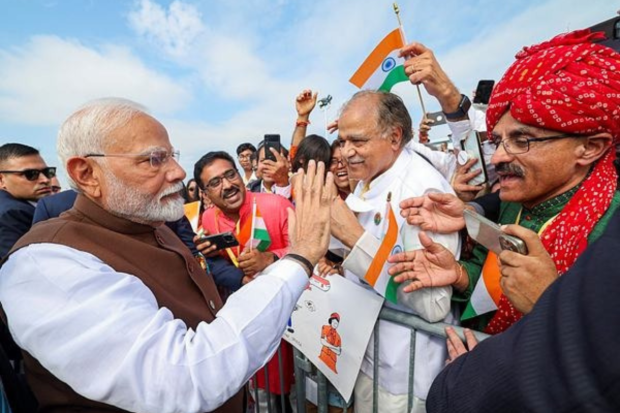Prime Minister Narendra Modi is being greeted by Indian Americans at the airport in Philadelphia. (PTI Photo)