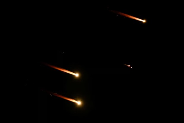 Rockets streaked through the sky, illuminating the horizon as seen from Tel Aviv, Israel. The sounds of explosions echoed in the distance, creating an atmosphere of tension and urgency. (Reuters)