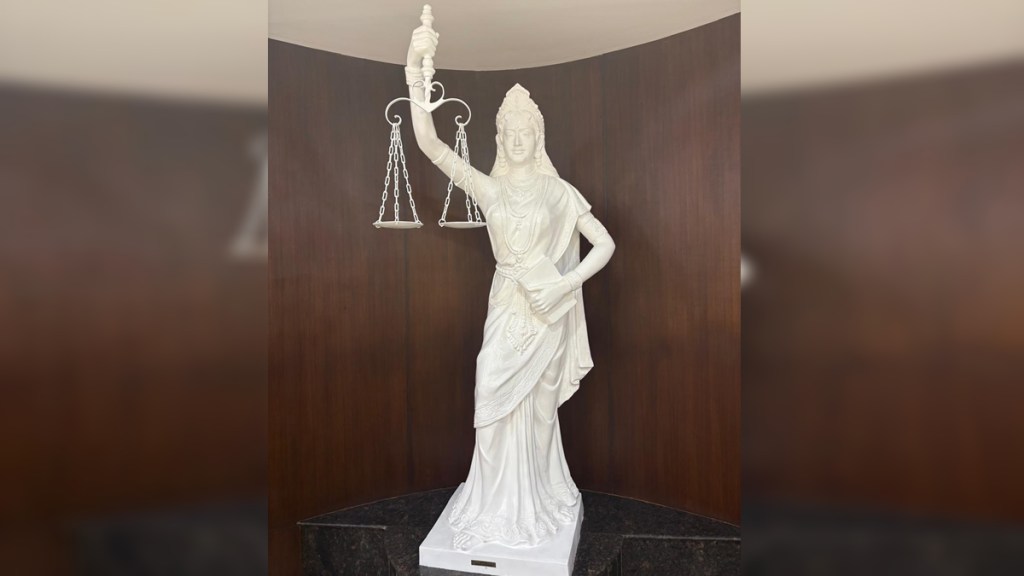 Blindfold off from New Lady Justice statue in Supreme Court, sword