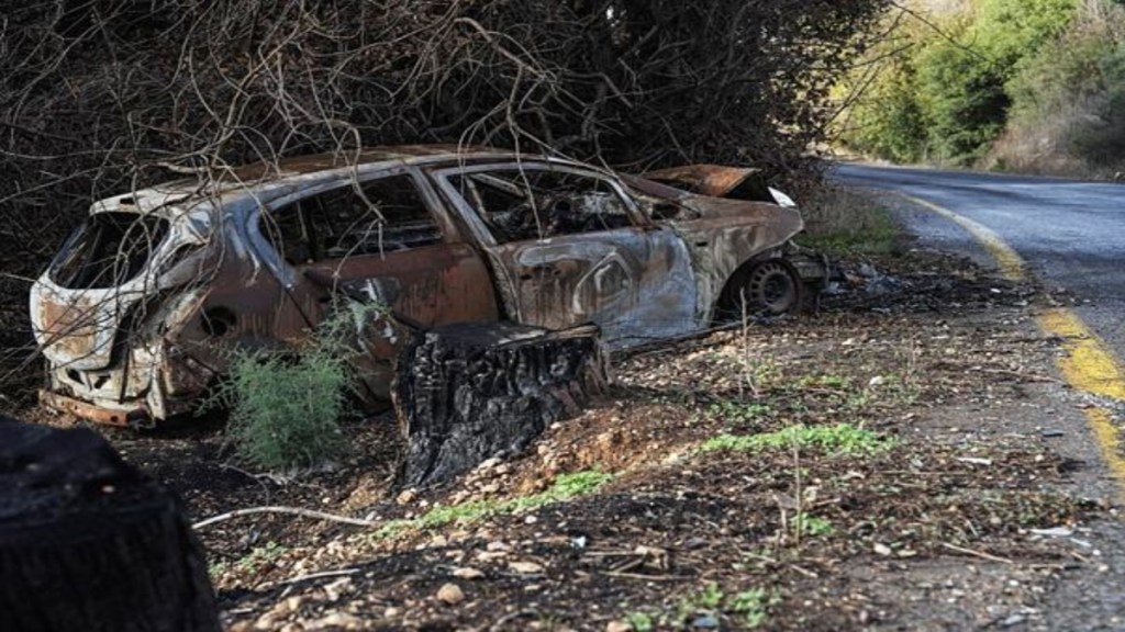 A burnt car is seen at the side of a road near the Israeli border with Lebanon, amid cross-border hostilities between Hezbollah and Israel, in northern Israel , November 25, 2024. REUTERS