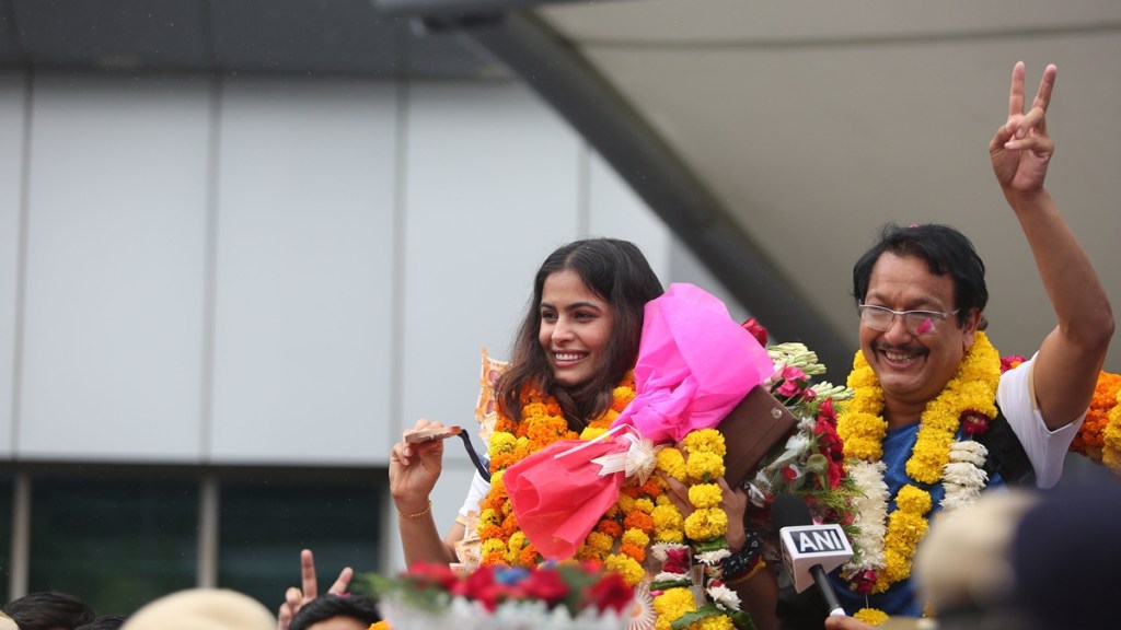 Double Olympic bronze medal-winning shooter Manu Bhaker was given a grand welcome at the Delhi airport on wednesday. Manu's coach was also seen with her. Express Photo by Gajendra Yadav.