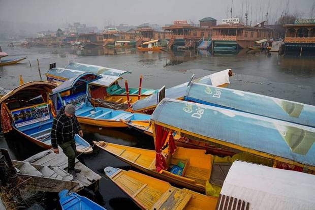 Shikaras harboured at the partially frozen Dal Lake, in Srinagar. (Photo source: PTI)