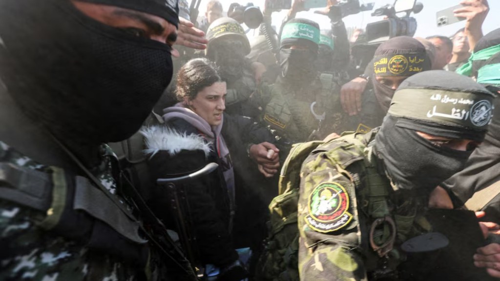 Palestinian militants surround hostage Arbel Yehoud, held in Gaza since the deadly October 7 2023 attack, on the day they hand her over. (Image Source: Reuters)