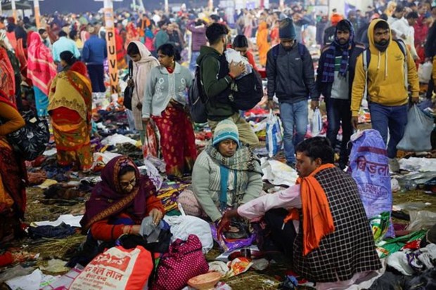Hindu devotees sit after a deadly stampede occurred before the second 