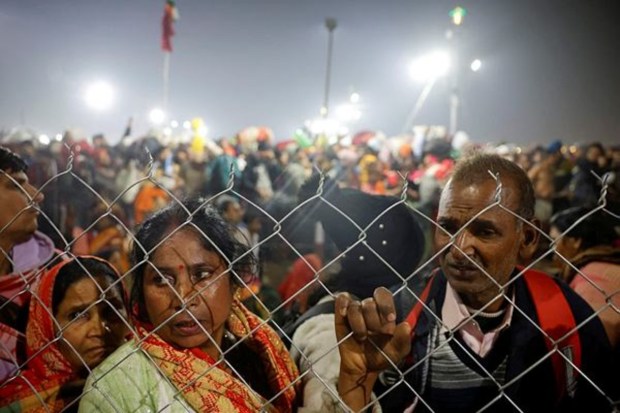 Hindu devotees are stopped by policemen after a deadly stampede occurred before the second 