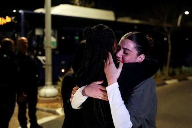 Women comfort each other as people gather, on the day of the arrival of Romi Gonen, Doron Steinbrecher and Emily Damari, three former female hostages who have been held in Gaza since the deadly October 7 2023 attack. (Photo source: Reuters)
