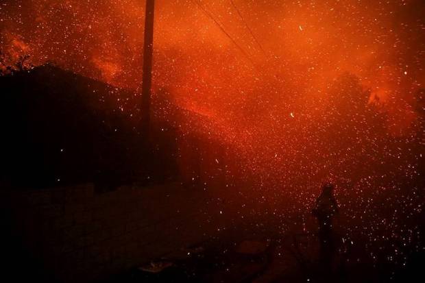 A firefighter stands among flying sparks as the Eaton Fire burns in Pasadena, California. (Photo source: Reuters)
