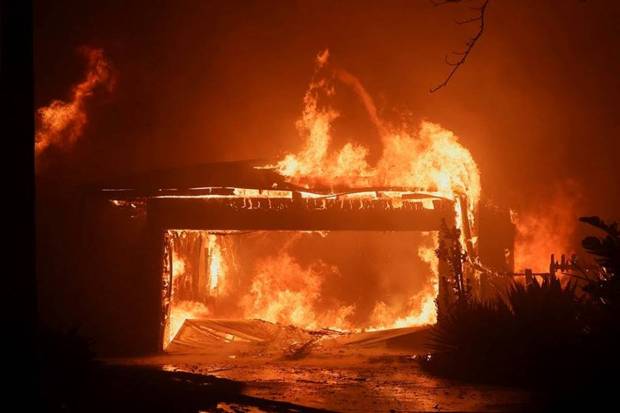 Flames rise from a structure as the Eaton Fire burns in Pasadena. (Photo source: Reuters)