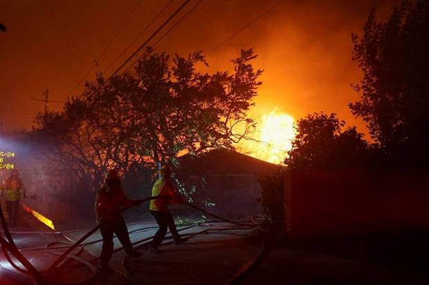 Firefighters work to extinguish flames as the Eaton Fire burns. (Photo source: Reuters)