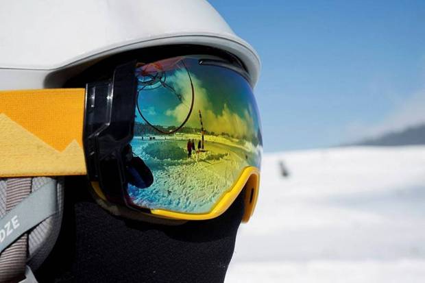 A reflection in ski goggles shows people in a snow-covered field in Gulmarg, a ski resort and one of the main tourist attractions in the Kashmir region, January 7, 2025. (Photo source: Reuters)