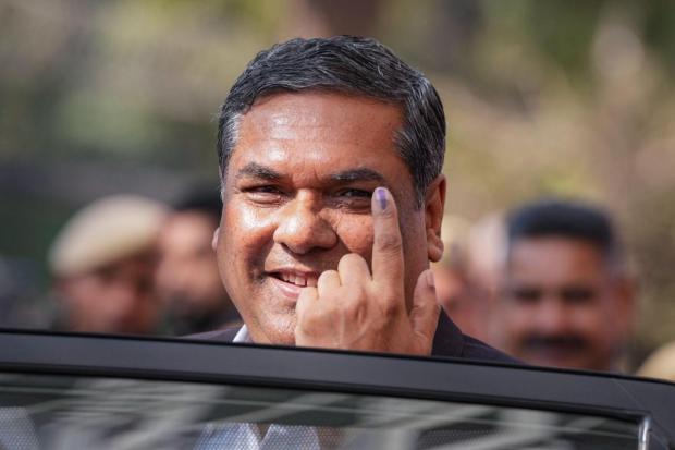 Chief Justice of India Sanjiv Khanna shows his finger marked with indelible ink after casting his vote at a polling booth during the Delhi Assembly elections.