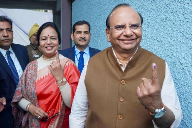 Delhi LG VK Saxena shows his finger marked with indelible ink after casting vote during the state Assembly elections, at Civil Lines.