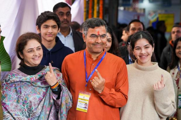BJP candidate Parvesh Sahib Singh Verma with his family after casting his vote at a polling booth during the Delhi Assembly elections.