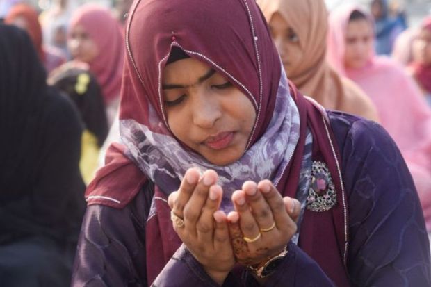 A still from Galle face in Colombo, Sri Lanka as a woman attends prayers on the occasion of Eid. . (Image: Reuters)