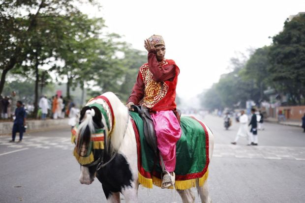 A member at a Dhaka procession stopped to rest after celebrations in the Eid-al-Fitr rally marking the end of holy month of Ramadan. (Image: Reuters)