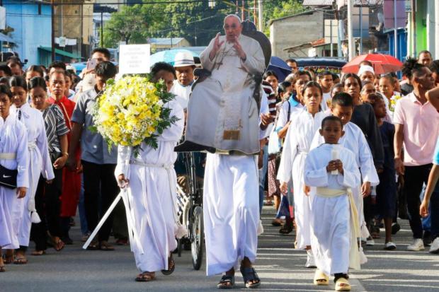 Timorese Catholics carry a cut-out of Pope Francis during a procession ahead of a prayer service, following his death, in Dili, East Timor.