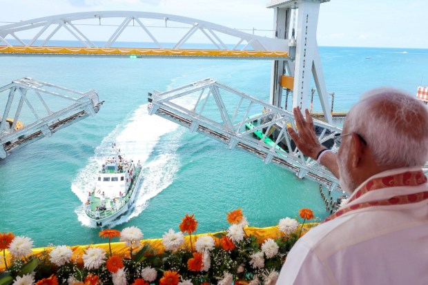 Rameswaram: A Coast Guard ship sails under the newly-inaugurated Pamban sea bridge during its launch by Prime Minister Narendra Modi. (Image: PTI)