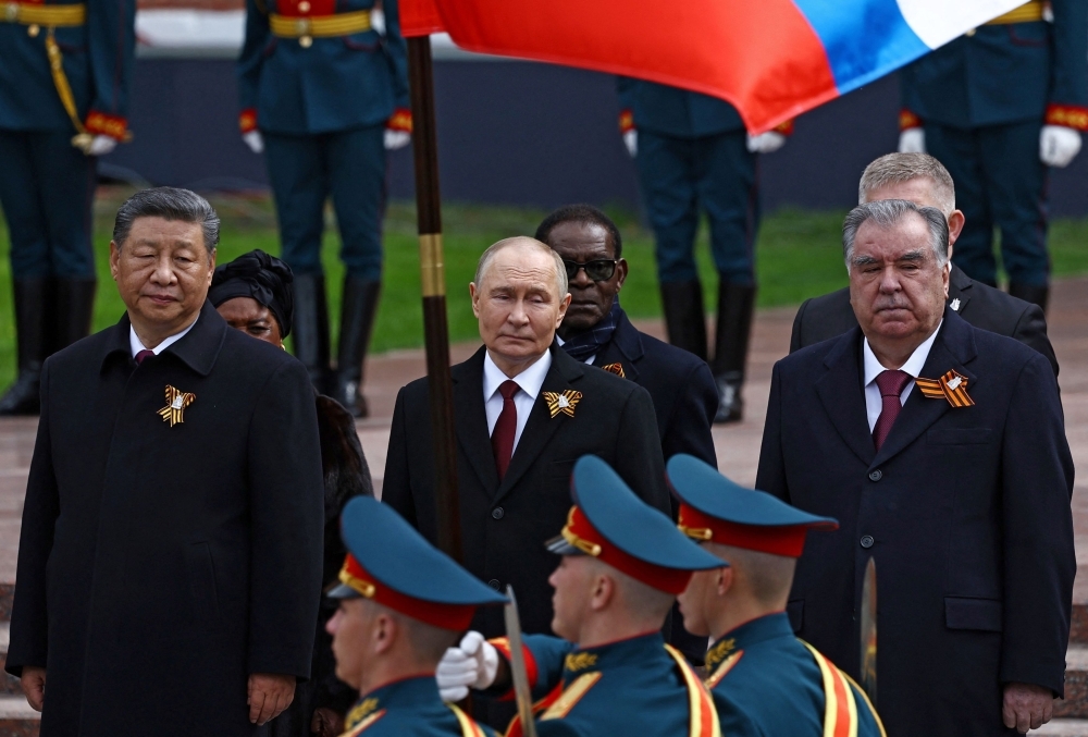 Russian President Vladimir Putin and Chinese President Xi Jinping watch the Victory Day military parade in Moscow