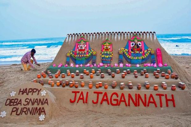 Sand artist Sudarsan Pattnaik has created a sand sculpture of Lord Jagannath, Lord Balabhadra, and Goddess Subhadra, along with 108 'kalash' installations, for 'Deba Snana Purnima' at Puri beach. (Image Source: PTI)