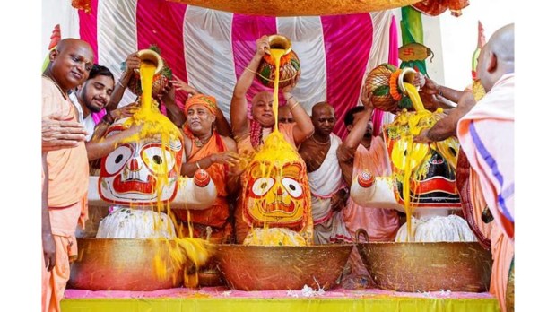 Hindu priests are conducting 'Purnima Snana, (a sacred bath) rituals for Lord Jagannath, Balabhadra, and Subhadra at a temple in Agartala. (Image Source: PTI)